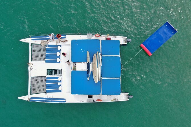 Cabo San Lucas All-Inclusive Private Catamaran Snorkeling Cruise - Paddle boards, kayaks, snorkeling gear, and a floating mat