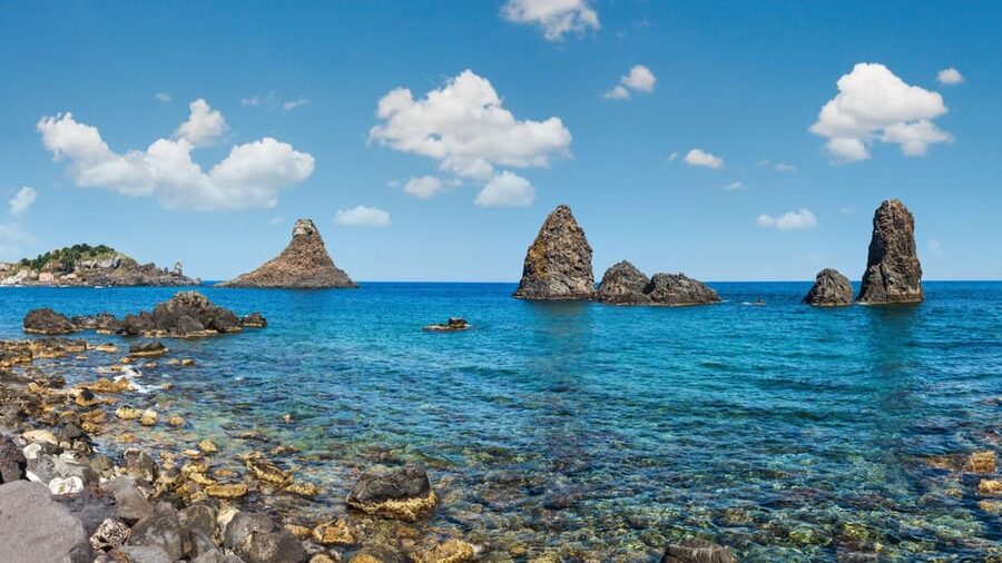 Catania: Boat Trip with Aperitif, Prosecco and Snorkeling - Approaching Aci Castello: Byzantine-era cliff views