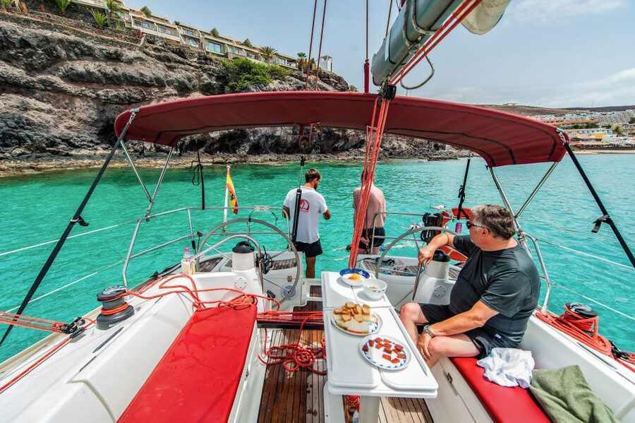 Fuerteventura: Sailing with Snorkeling and Dolphin Watching - Sailing out past the coast: engine-off energy and captain radio work