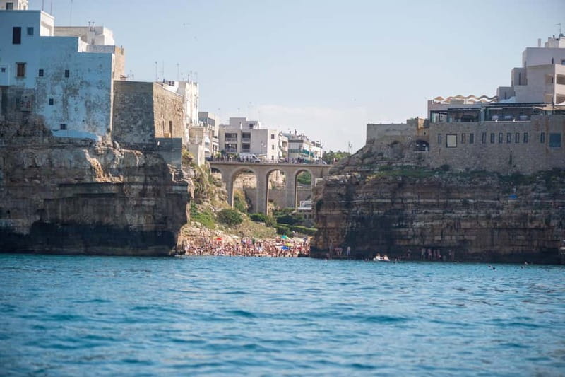 Polignano a Mare: Eco Boat Tour with Snorkeling and Caves - First cruise stop: the Domenico Modugno monument photo moment