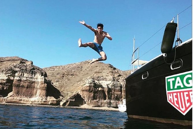 Santorini Adventurous Catamaran Experience with Snorkeling - Passing Akrotiri’s Venetian Lighthouse: cliff edges, old-world charm, and big sightlines