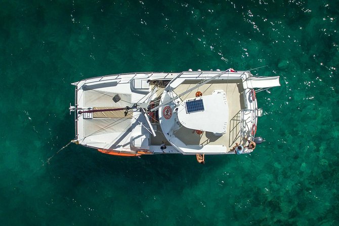 Small Group Snorkeling Cruise with Open Bar and Light Snacks - On-board fun: slide toboggan, floating bar, and paddle board