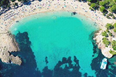 Sunset Beach Hopping Cruise, Cala Comte and Cala Bassa, SUP and snorkelling - Stop 1 Cala Comte: Family-Friendly Beach Energy and Great Place to Eat Later